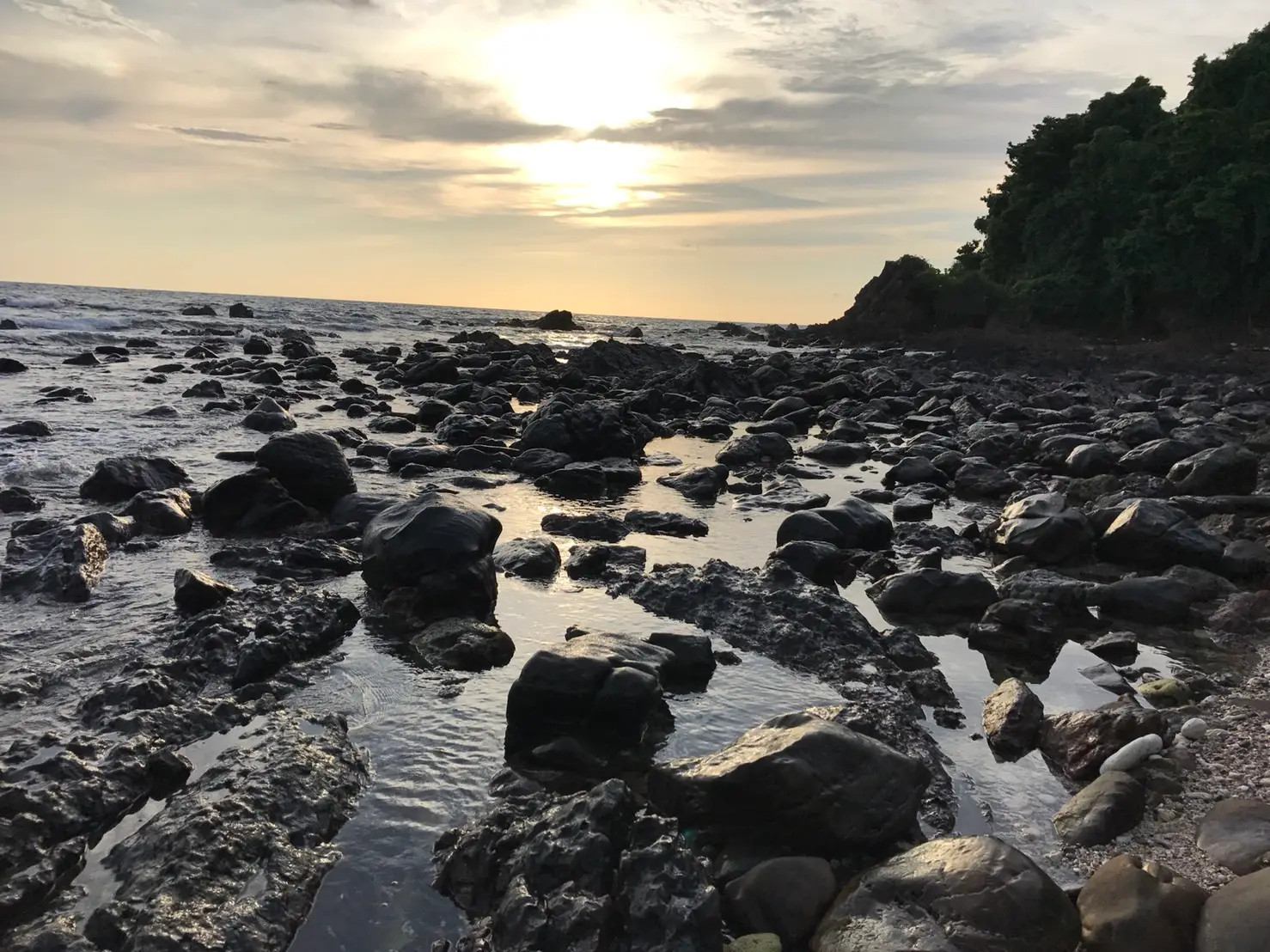 Rocks along the shore of Koh Kradan at sunset