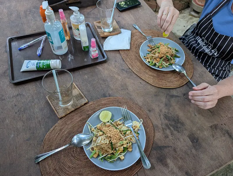 Two plates of pad thai on a table at a Thai cooking school in Sukhothai
